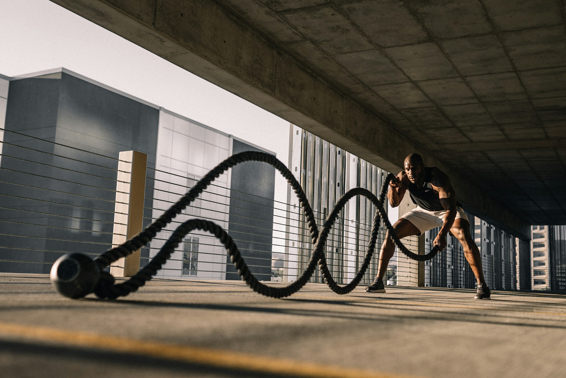 Athlete training with battle ropes in a gym