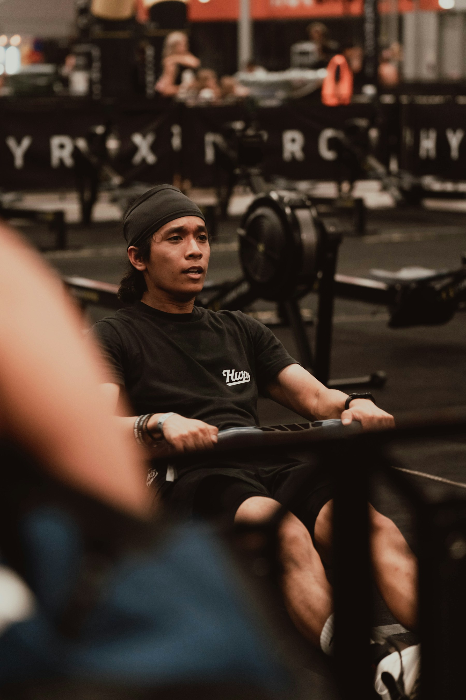 Athlete training on a rowing machine in a gym